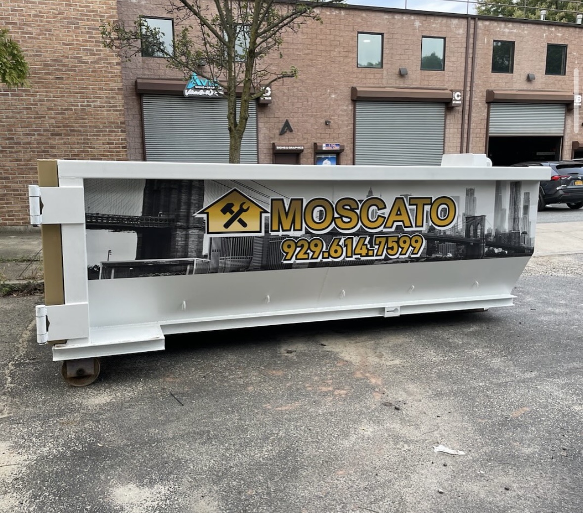 Moscato 20-yard roll-off container branded with company logo and phone number